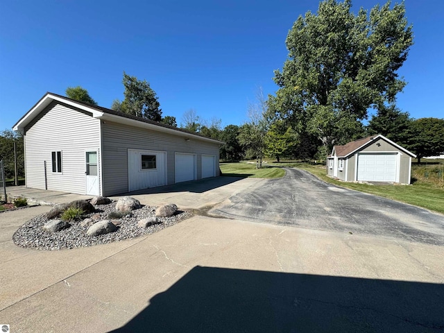 view of side of home with an outbuilding and a garage