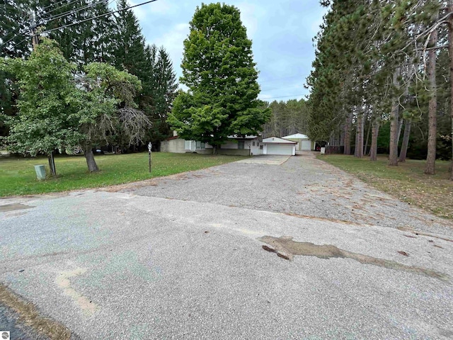 exterior space with a garage and a front lawn