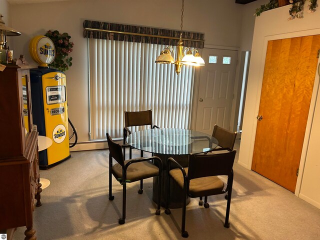 carpeted dining area with baseboard heating and a notable chandelier