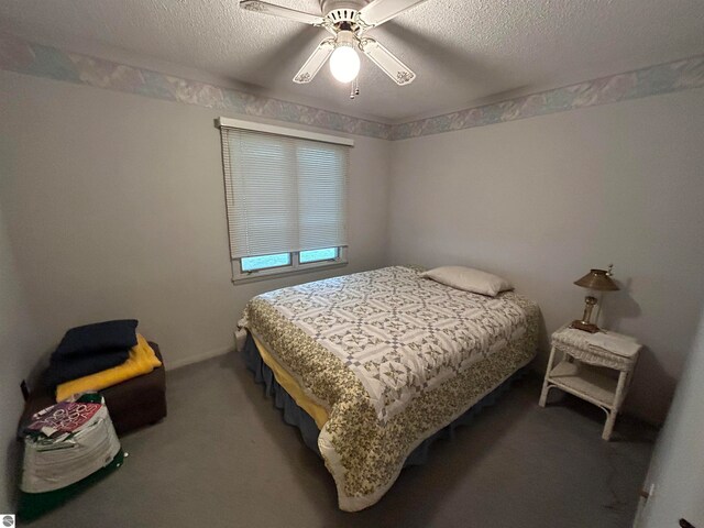 bedroom featuring a textured ceiling, ceiling fan, and carpet flooring