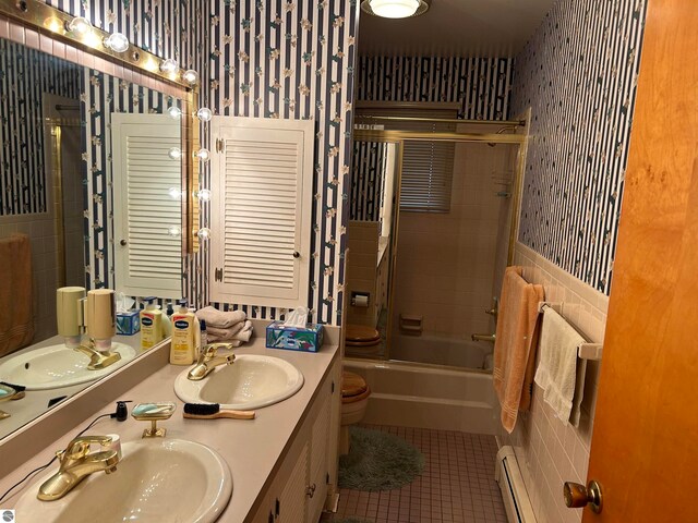 full bathroom featuring toilet, tile patterned floors, shower / bath combination with glass door, vanity, and a baseboard radiator