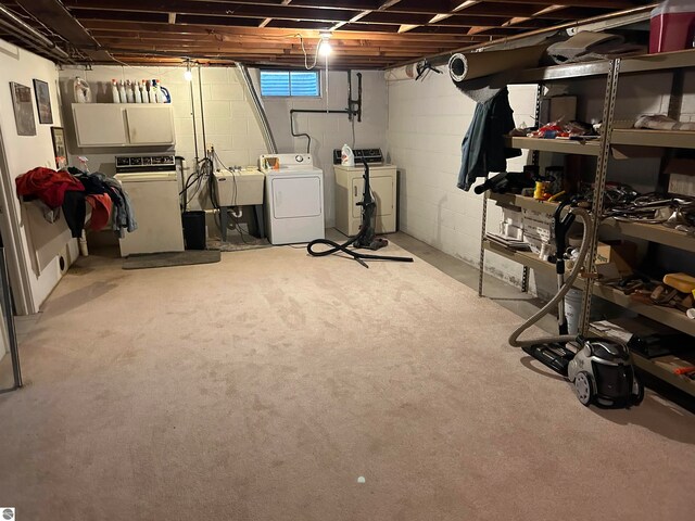 basement with sink and washer and dryer