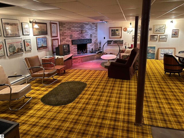 carpeted living room with a fireplace, a baseboard radiator, and a paneled ceiling