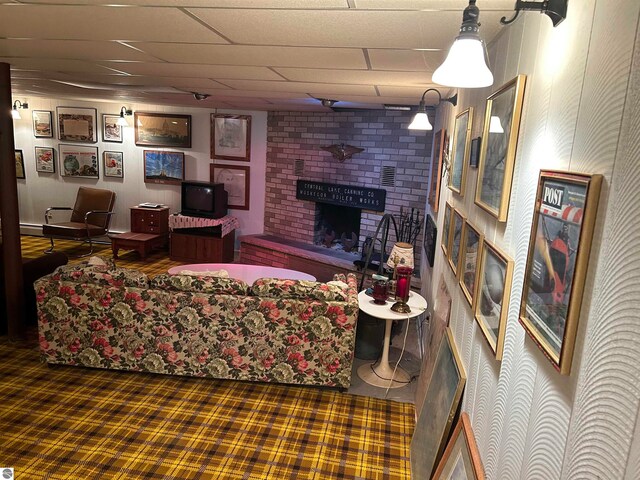 living room with a brick fireplace and carpet