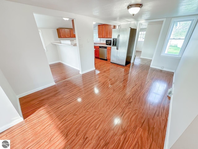 kitchen with stainless steel appliances and light hardwood / wood-style floors