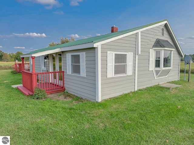 exterior space featuring a yard and a wooden deck