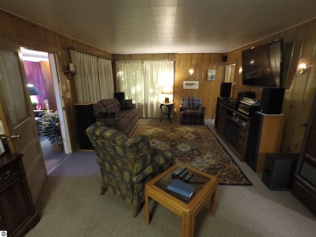 living room featuring light carpet and wood walls