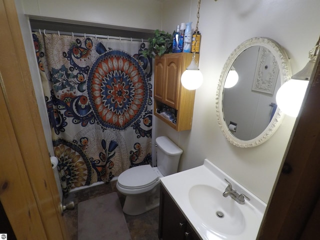 bathroom featuring toilet, vanity, and a shower with shower curtain