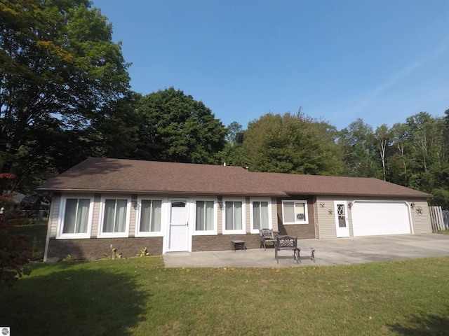 single story home with a garage and a front lawn