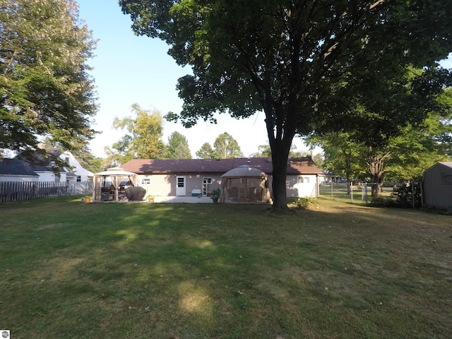 view of yard featuring a gazebo and a storage unit