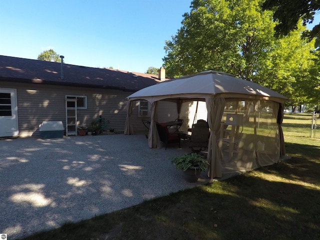 rear view of house with a gazebo and a patio area