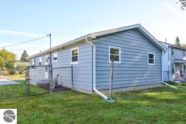 view of side of home featuring a lawn