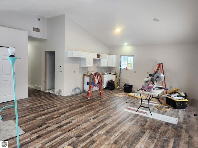 rec room with dark hardwood / wood-style floors and high vaulted ceiling