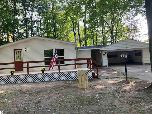 view of home's exterior featuring a wooden deck, a garage, and an outdoor structure