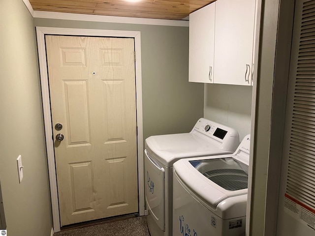 laundry room featuring wooden ceiling, crown molding, cabinets, and washing machine and dryer