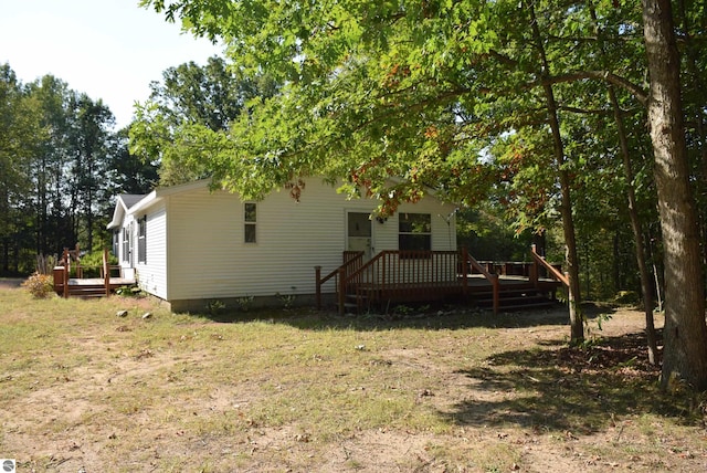 rear view of property with a wooden deck