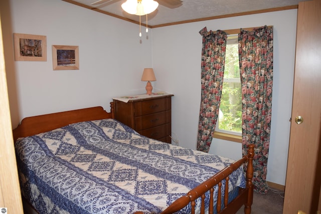 bedroom featuring ceiling fan, crown molding, and carpet floors