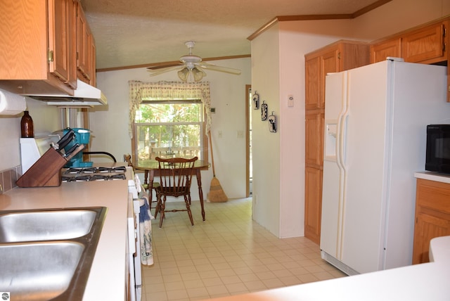 kitchen with ornamental molding, sink, white refrigerator with ice dispenser, a textured ceiling, and ceiling fan