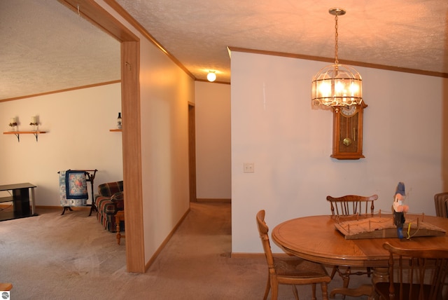 dining space featuring a textured ceiling, carpet floors, an inviting chandelier, and ornamental molding