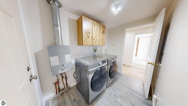 kitchen with backsplash, dishwasher, light hardwood / wood-style flooring, sink, and a baseboard heating unit