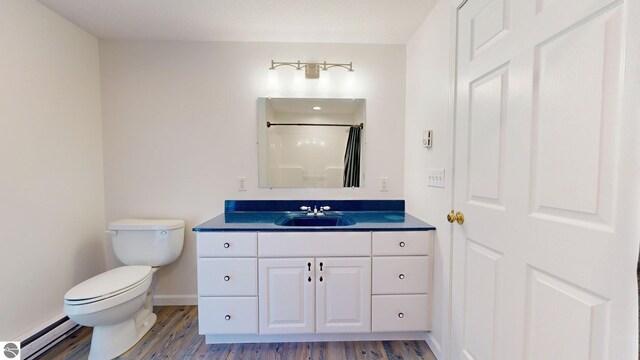 kitchen with light hardwood / wood-style floors, stainless steel appliances, and a baseboard radiator