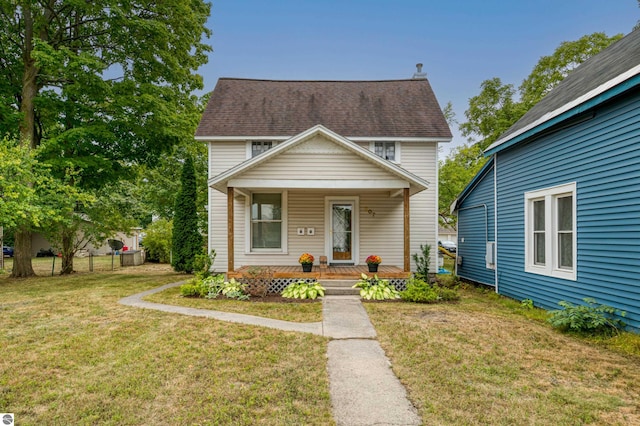 view of front of home featuring covered porch and a front yard