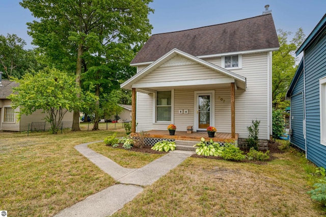 view of front of home with a front yard and covered porch