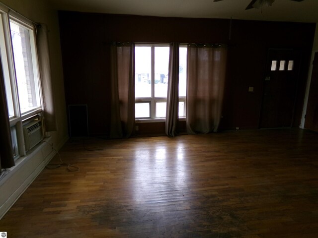 unfurnished room featuring ceiling fan and dark hardwood / wood-style floors