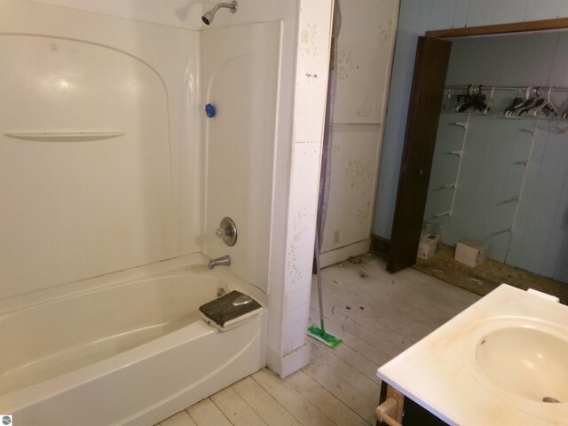 bathroom featuring bathtub / shower combination, hardwood / wood-style flooring, and vanity