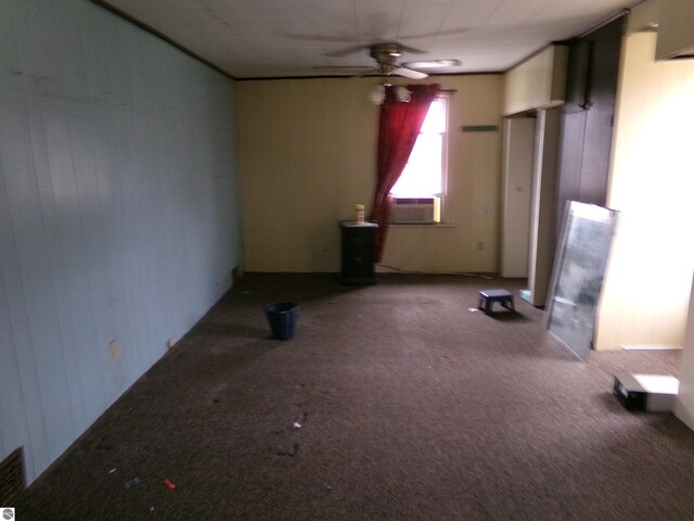 empty room with carpet flooring, ceiling fan, and cooling unit