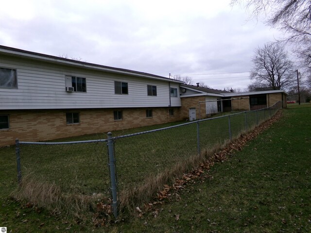 rear view of property with a lawn