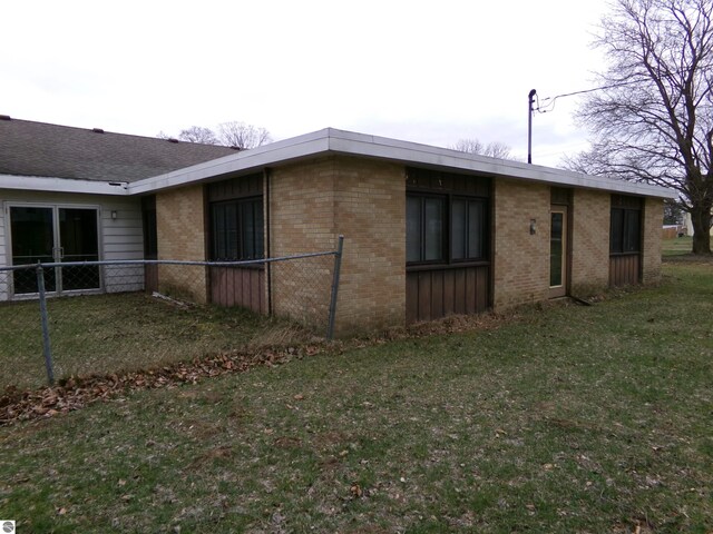 view of side of home featuring a lawn