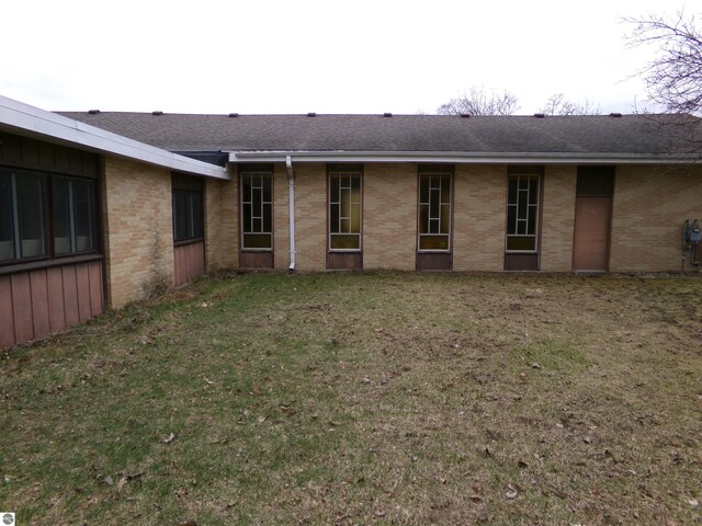 rear view of property with a yard