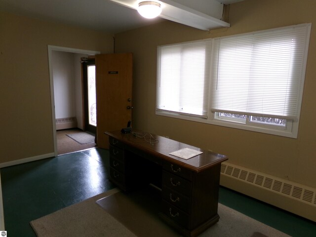 unfurnished office featuring a baseboard radiator