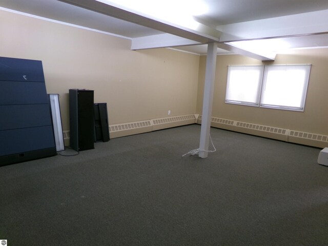 basement with a baseboard heating unit and carpet flooring