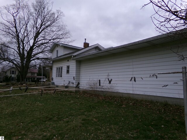 view of home's exterior with a yard