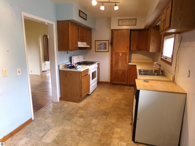 kitchen featuring sink and white range with gas cooktop