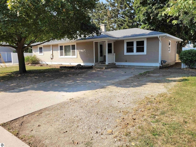 ranch-style house with a front yard and a porch