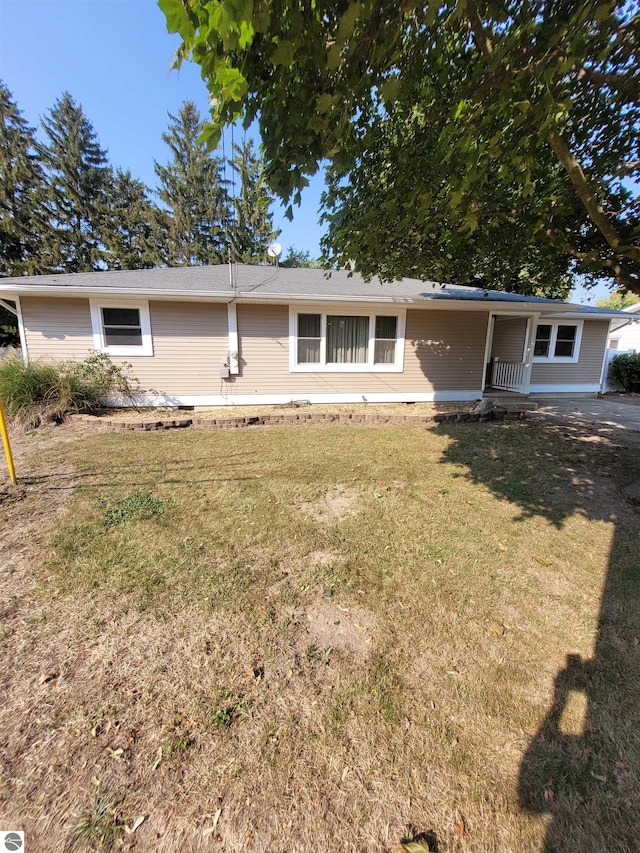 rear view of house with a yard