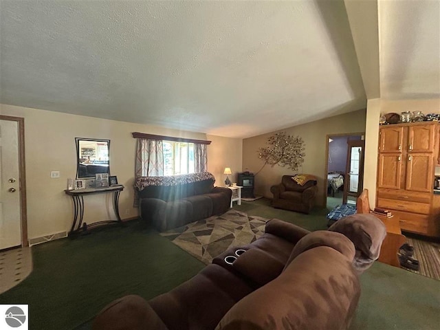 living room with carpet floors, a textured ceiling, and vaulted ceiling