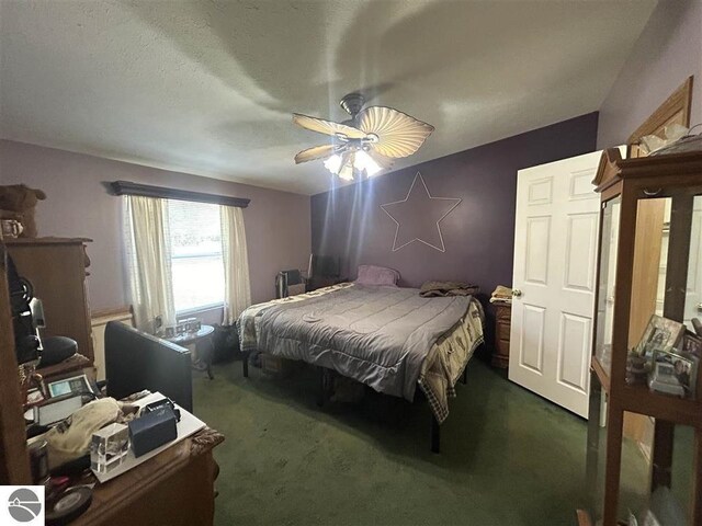 carpeted bedroom with a textured ceiling and ceiling fan