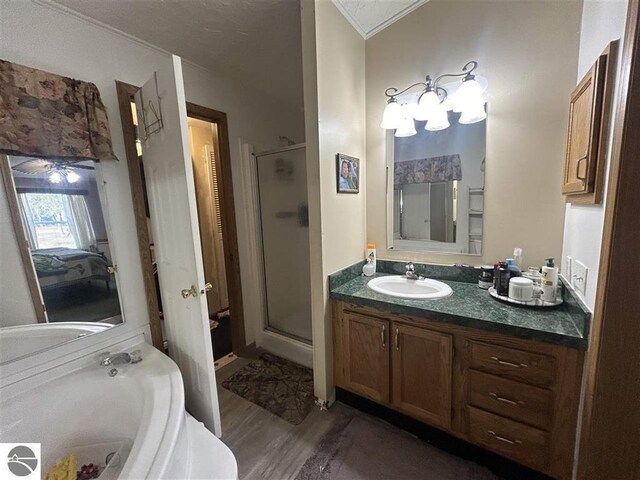 bathroom with ceiling fan, vanity, separate shower and tub, hardwood / wood-style flooring, and crown molding