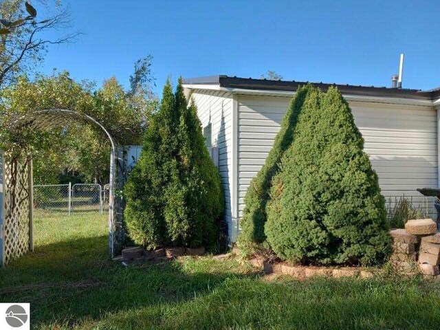 view of property exterior featuring a lawn