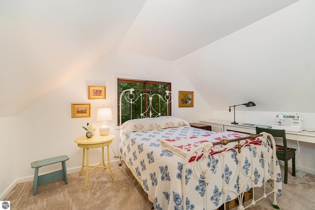 carpeted bedroom featuring lofted ceiling