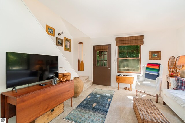 living room featuring light colored carpet and lofted ceiling