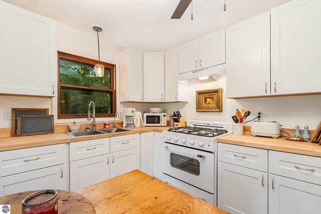 kitchen with hanging light fixtures, white appliances, and white cabinetry