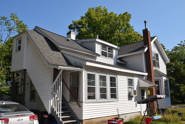 413 N Fancher St, Mount Pleasant, MI 48858 - view of home's exterior featuring roof with shingles and a chimney