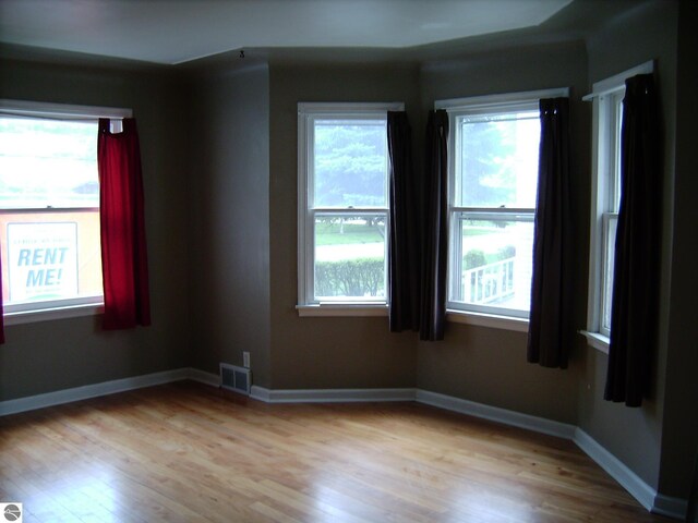 413 N Fancher St, Mount Pleasant, MI 48858 - empty room featuring visible vents, baseboards, and light wood-style floors