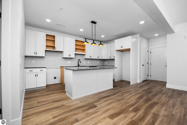 kitchen featuring a kitchen island, white cabinetry, and hardwood / wood-style flooring