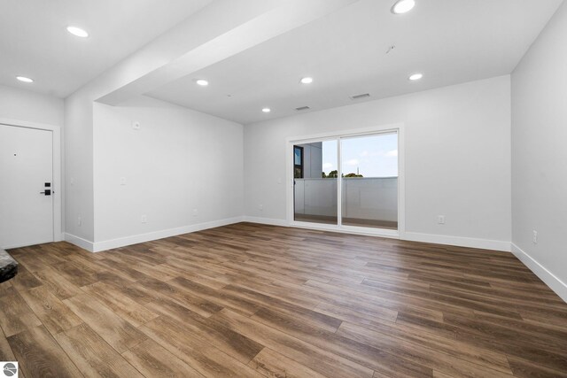 empty room with dark hardwood / wood-style floors